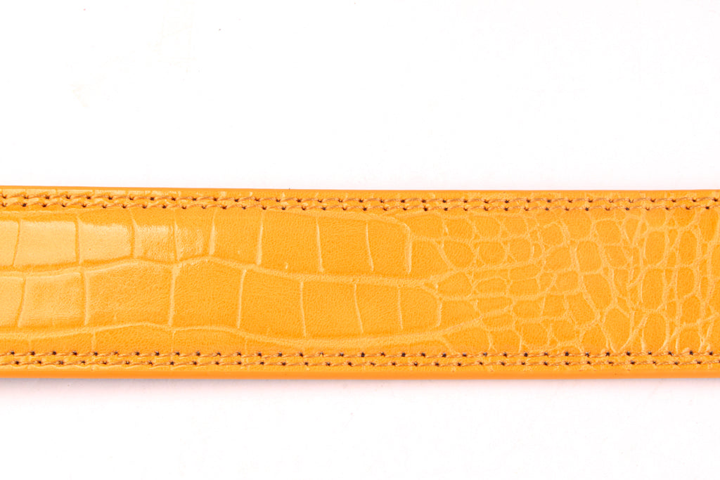 Women's faux gator belt strap in orange, 1.25 inches wide, formal look, flat lay