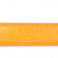 Women's faux gator belt strap in orange, 1.25 inches wide, formal look, flat lay