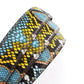 Women's vegan leather belt strap in multi-colored boa print, light blue and yellow, 1.25 inches wide, casual look, full roll, slanted view